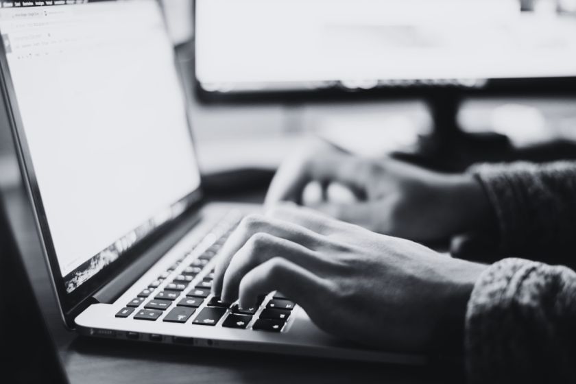 A person typing on a laptop, illustrating the author blog concept.